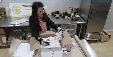 Woman packing beef in a box